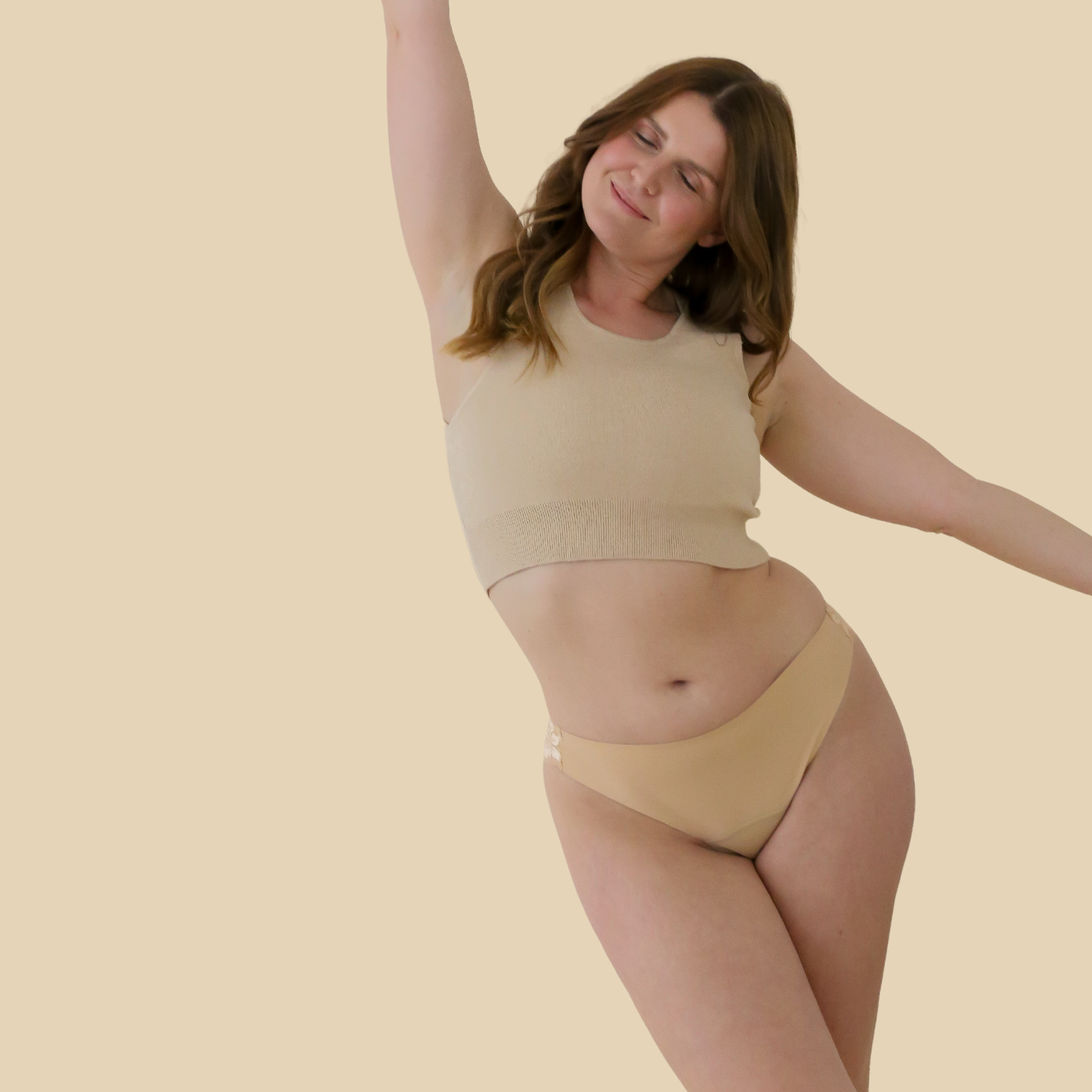 dais daily underwear which is a sustainable alternative to panty liners and tampons. Used for light periods and discharge. In Brazilian cut with lace and beige colour shown on a model from the front. 