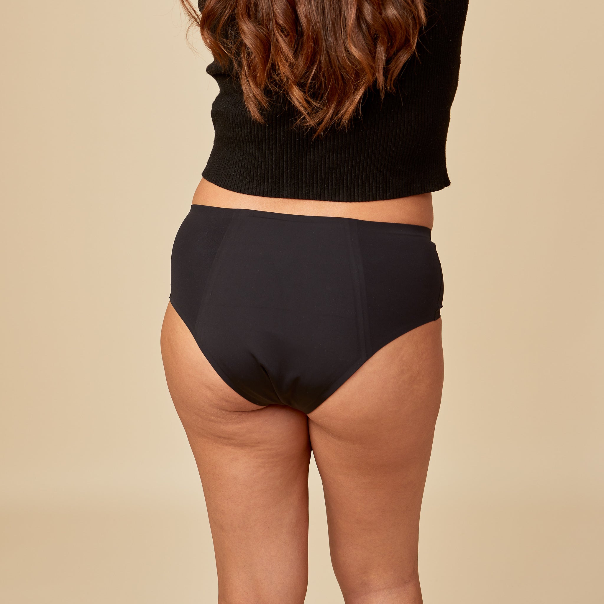 dais bladder leak underwear in black shown on model from the back. 
