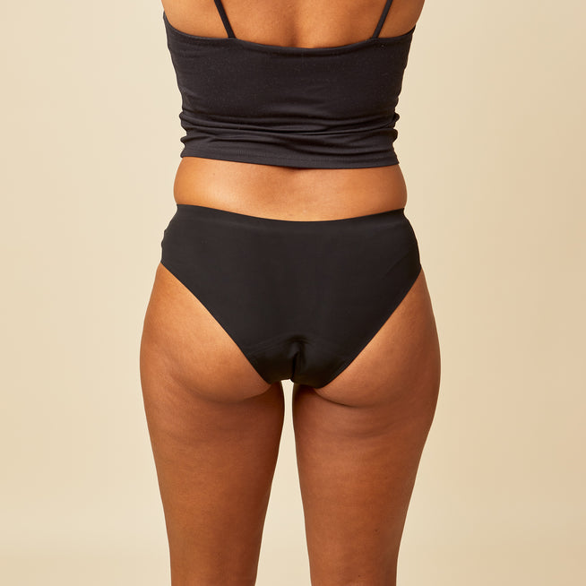 dais period underwear in cheeky cut in black shown on model from the black.